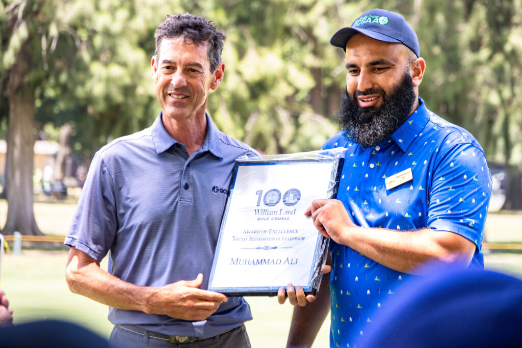 William Land Golf Course Superintendent Muhammad Ali is given an award for excellence and special recognition of leadership by another member of the GCSAA.
