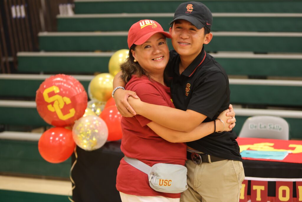 Jaden Dumdumaya hugs his mom after signing with USC.