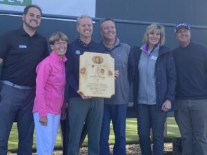 Members of Morton Golf Foundation and AJGA holding shadow box display case