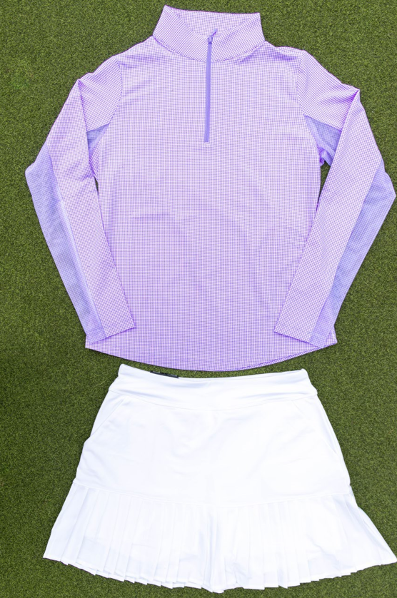 purple half zip with white skirt on grass background