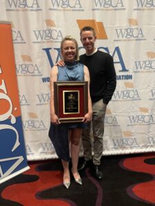 Chalotee Mayorkas and Mike Duhamel on red carpet with award