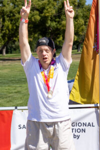 young man celebrating with his arms up