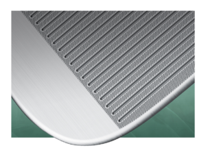Up close view of grooves on face of wedge against green background