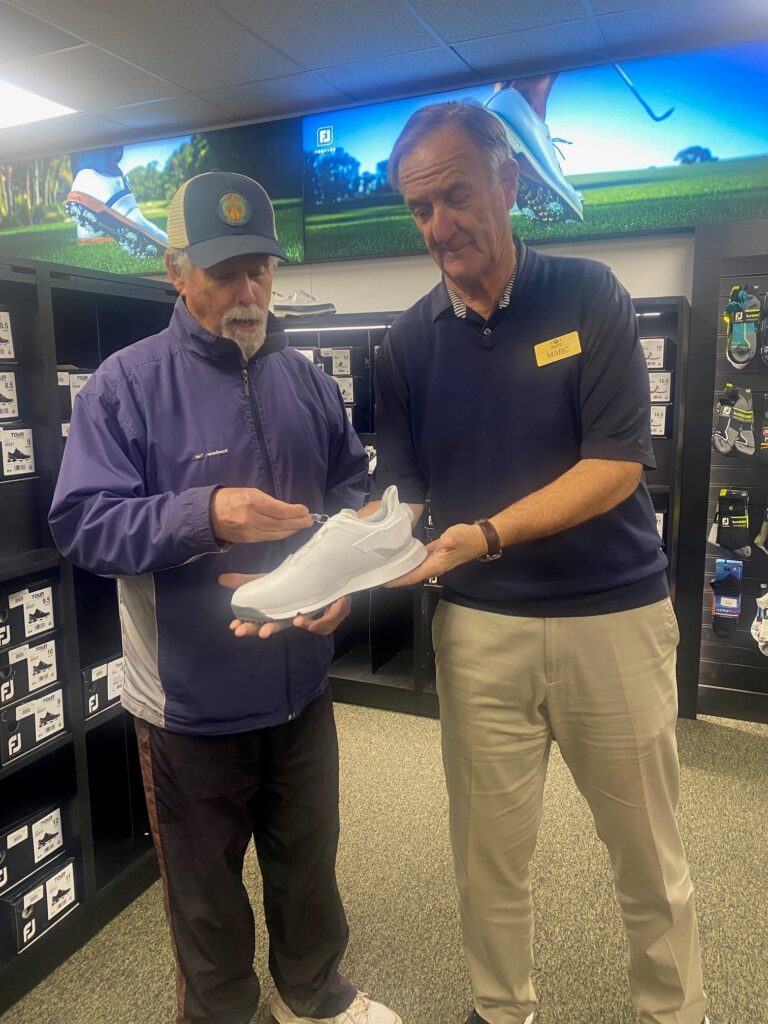 Two Men holding a shoe