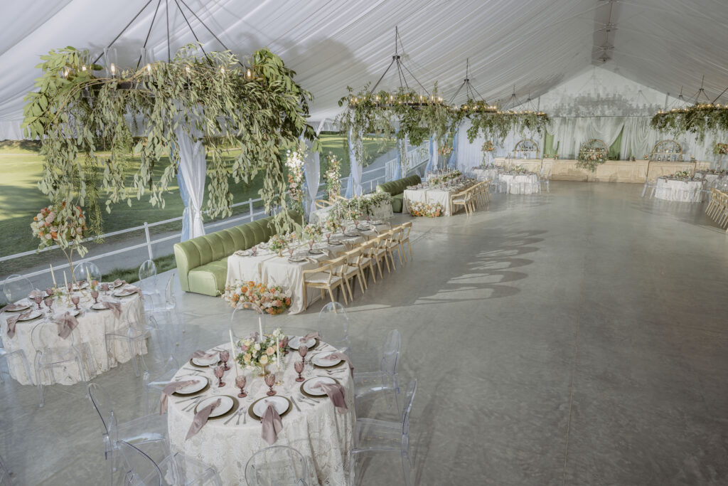 A raised, interior shot of the tent at Bartley Cavanaugh. Tables are set up for an event. A bar is seen against the far wall.