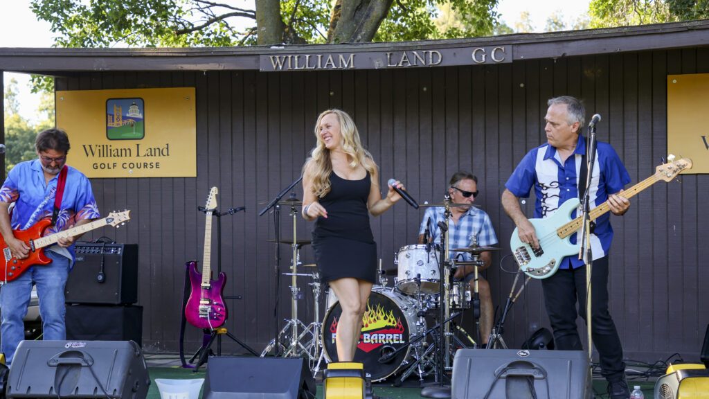 Four Barrel Band performing on the Swanson's Grove stage at William Land Golf Course.
