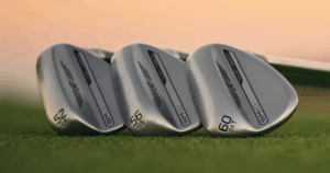 A close up of SM10 wedges lined up on grass