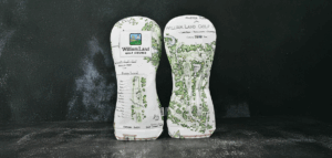 A close up of the William Land Master Plan headcover. It is covered front and back with a colored course sketch showing the proposed 100 year plan.