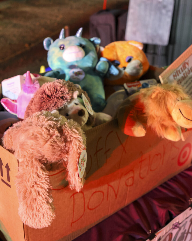 The donations box for the Sheriff's Toy Drive. The bow is full and some toys are hanging over the edges.