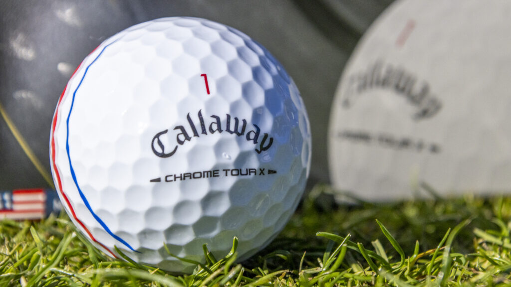 A close up of a Callaway Chrome Tour X ball with triple track lines.