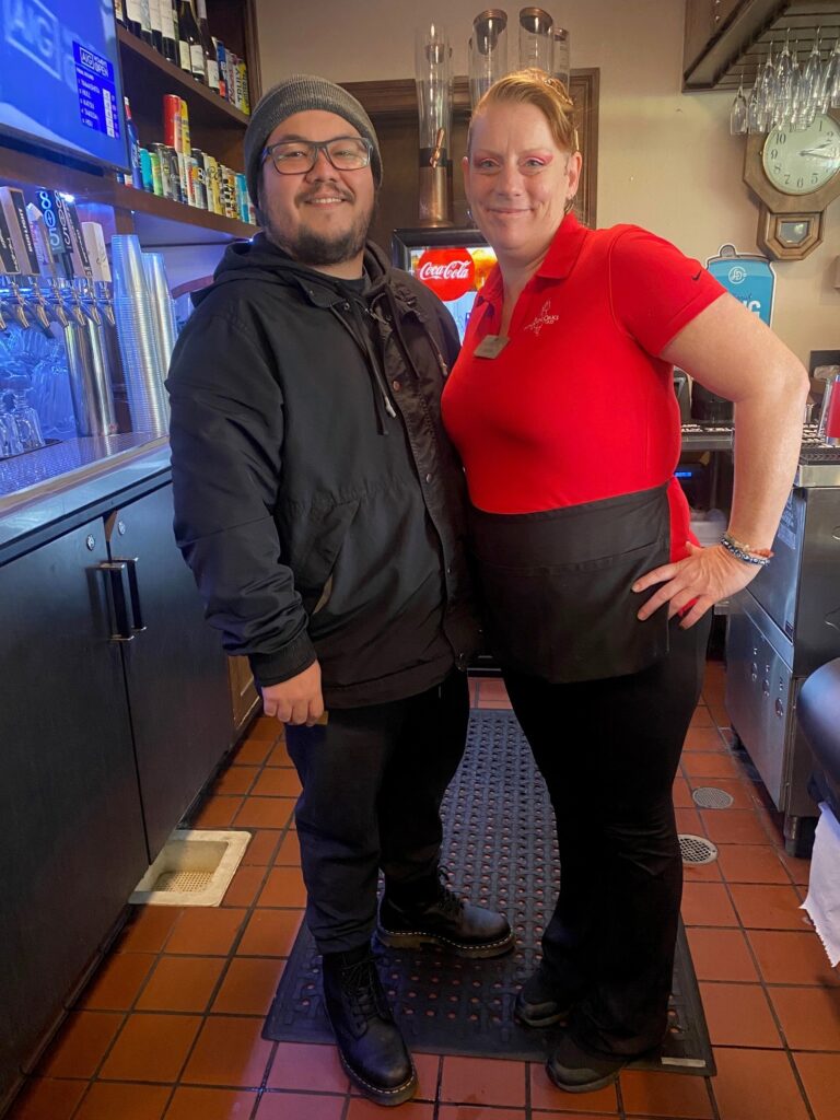 Steven Reschert and Amber Calhuan pose for a photo together behind the bar in MacKenzie's Sports Bar & Grille.