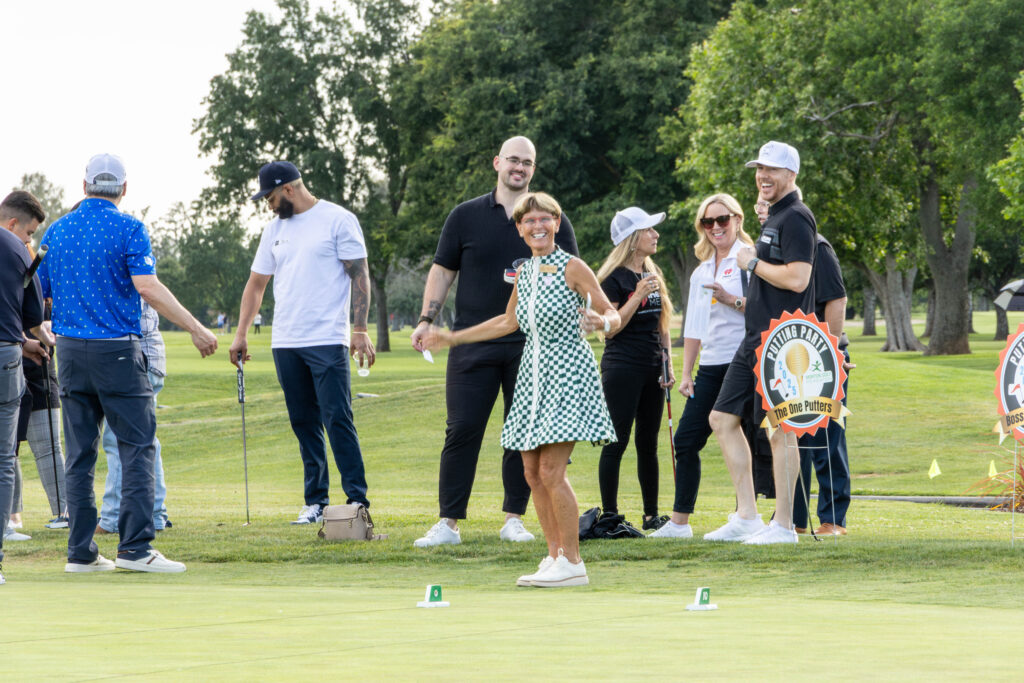 A crowd of people at the Morton Golf Foundation Putting Party from 2025. Jane Siebers is front a center, smiling.