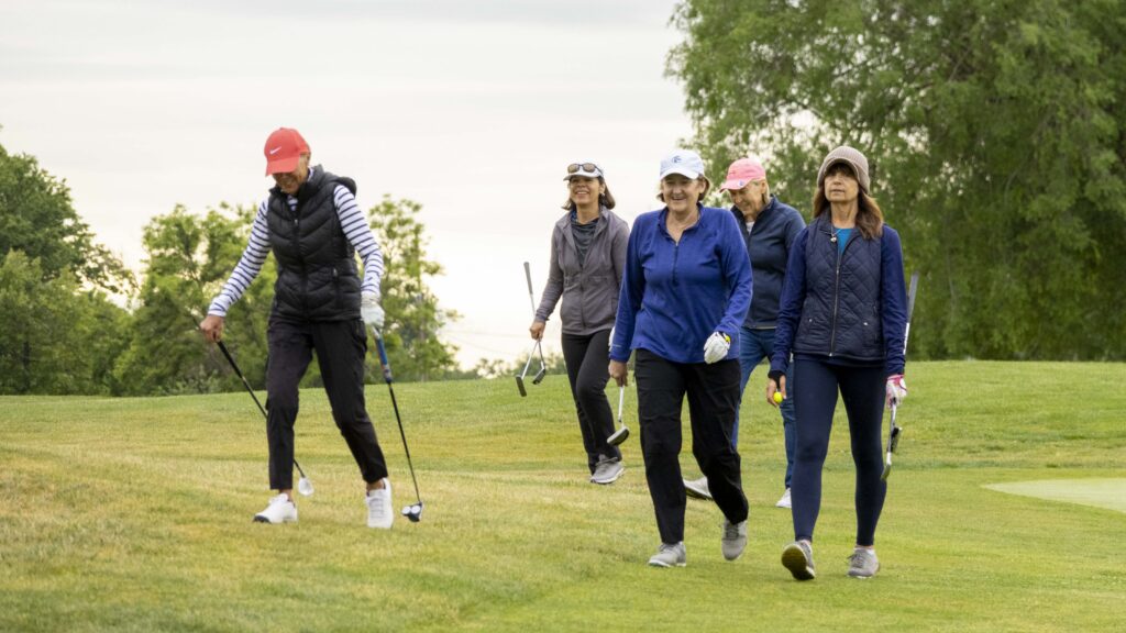 a group of female golfers walking