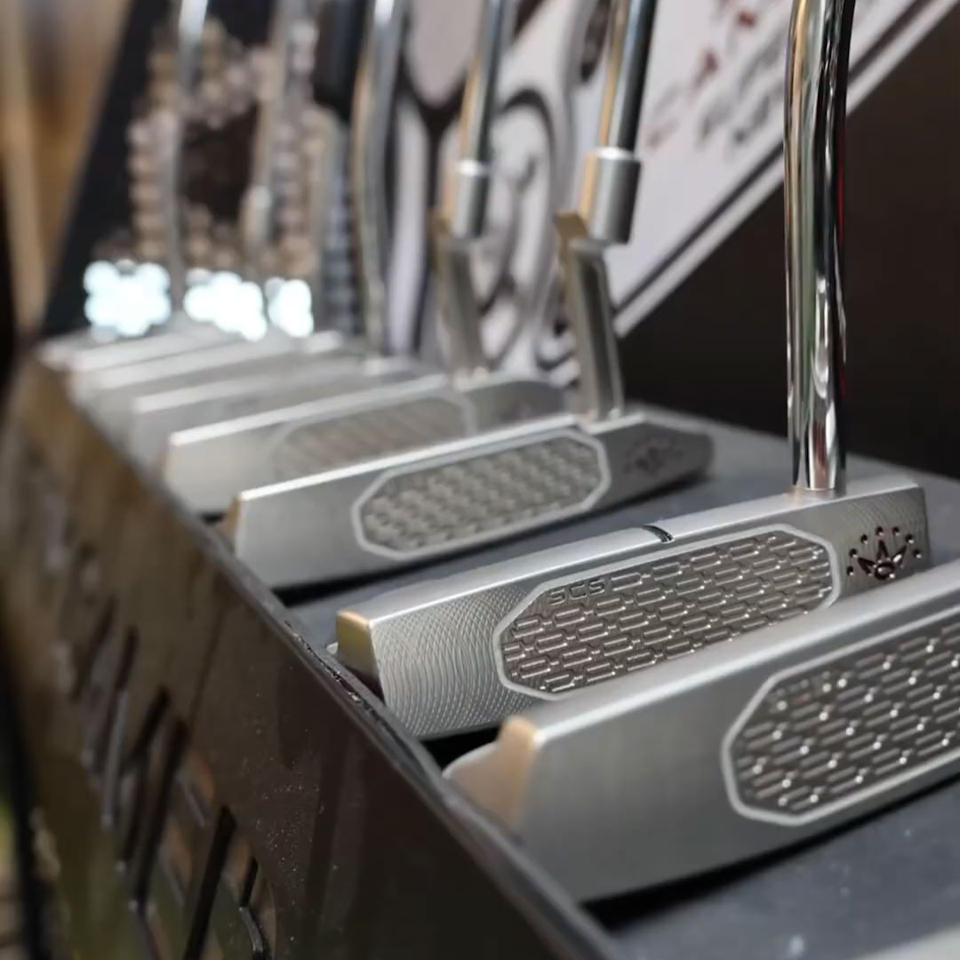 Selection of golf putters displayed in a fitting studio