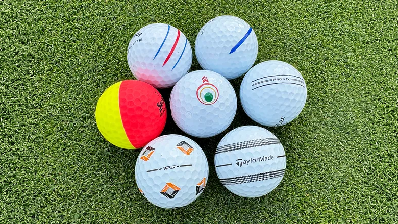 Several TaylorMade TP5 golf balls with different styles of alignment aids.
