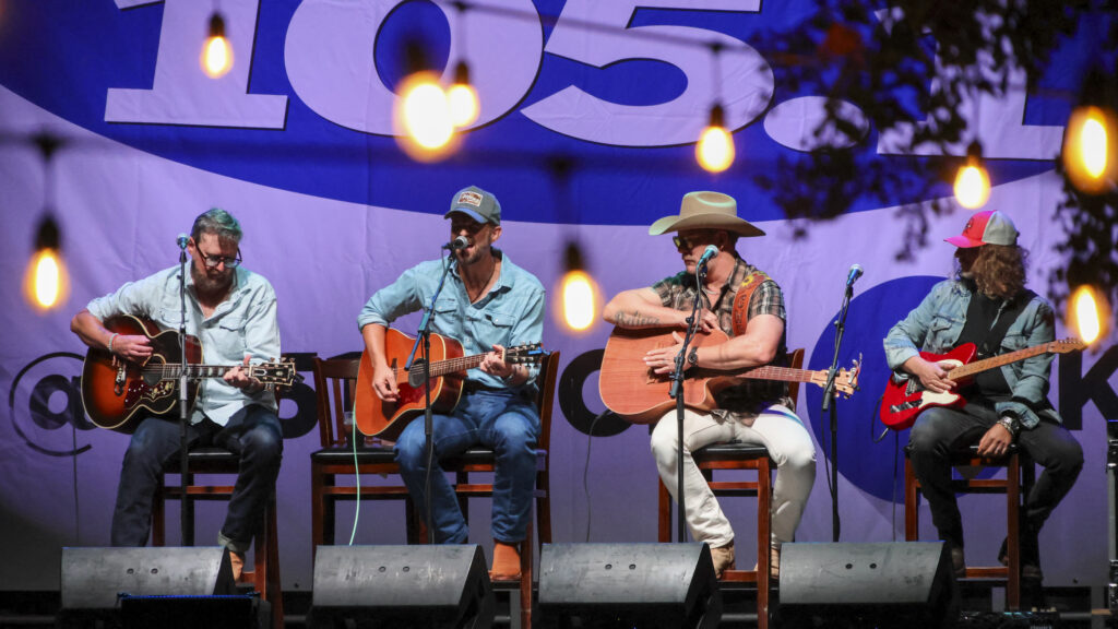 2 men performing music on a stage