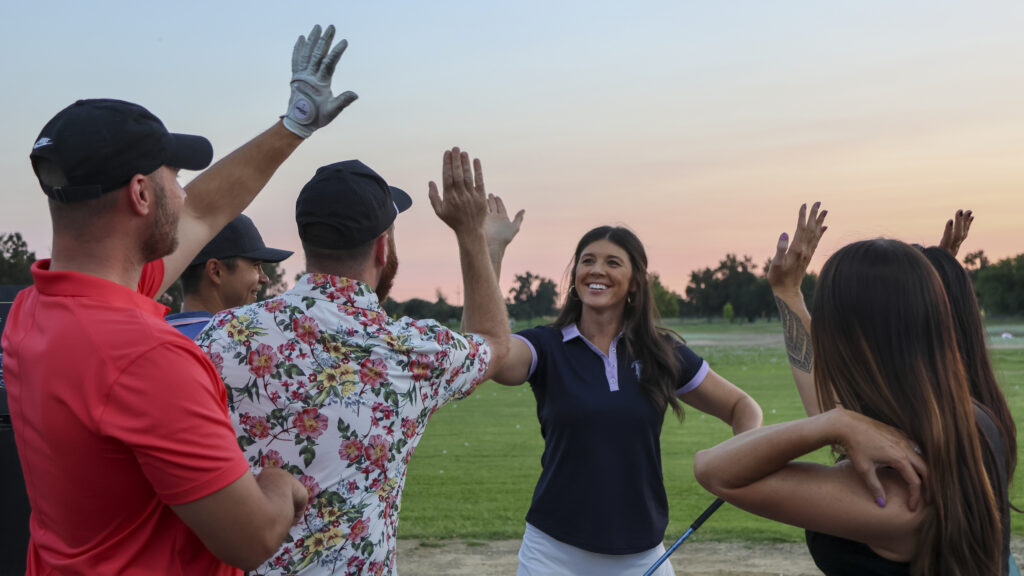 friends high fiving at the range